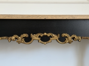 Close-up of handcrafted gilded ornament detail on Aurelia luxury console table.